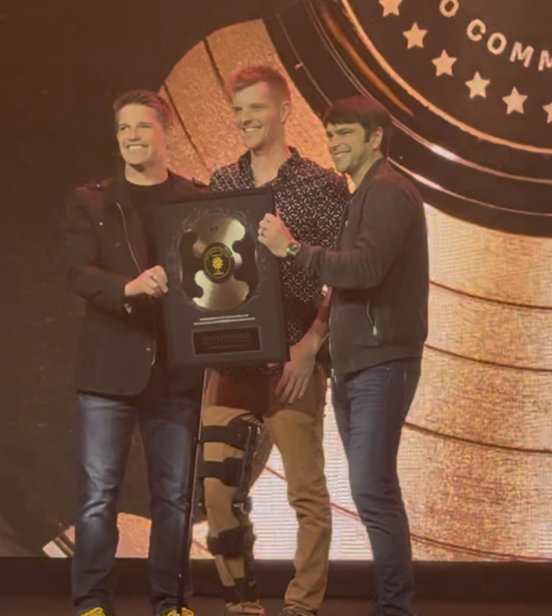Christian Martin accepting a Two Comma Club award on stage